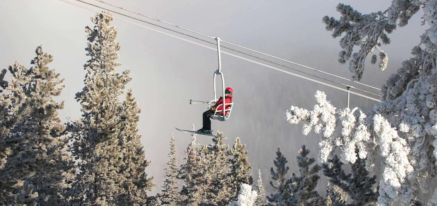 ski patrol riding the chairlift