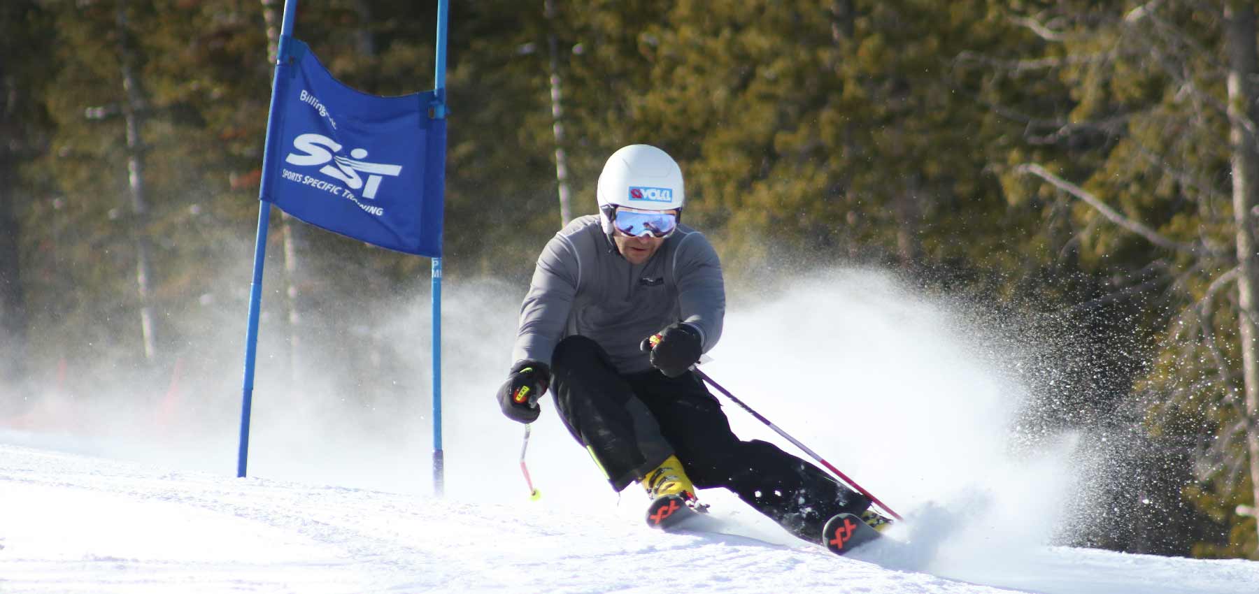 ski racer turning around a blue gate